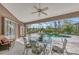 Covered patio with glass-top table and chairs overlooking the pool at 910 Park Place Dr, Englewood, FL 34223