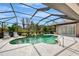 Enjoyable pool and patio area with a screened enclosure and lounge chairs at 910 Park Place Dr, Englewood, FL 34223