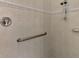 Walk-in shower with tiled walls and grab bar at 910 Park Place Dr, Englewood, FL 34223