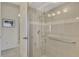 Walk-in shower with grab bars and glass enclosure at 910 Park Place Dr, Englewood, FL 34223