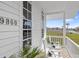 Exterior view of house with front porch and rocking chairs at 9860 Eagle Preserve Dr, Englewood, FL 34224