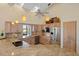 Bright kitchen featuring light wood cabinetry, granite counters, stainless steel appliances and natural light at 9860 Eagle Preserve Dr, Englewood, FL 34224