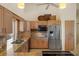 Bright kitchen featuring light wood cabinetry, granite counters, and stainless steel appliances at 9860 Eagle Preserve Dr, Englewood, FL 34224