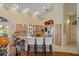 Bright kitchen featuring light wood cabinetry, granite counters, a breakfast bar and stainless steel appliances at 9860 Eagle Preserve Dr, Englewood, FL 34224