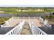 Stairs going down from rooftop deck overlooking the golf course at 9860 Eagle Preserve Dr, Englewood, FL 34224