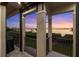 Balcony with a picturesque sunset and water view, providing an outdoor space for relaxation at 9861 Eagle Preserve Dr, Englewood, FL 34224