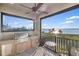 Outdoor kitchen on balcony with a grill and beautiful water views at 9861 Eagle Preserve Dr, Englewood, FL 34224