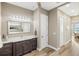 The bathroom features wood look floors, a large mirror, and modern vanity at 9861 Eagle Preserve Dr, Englewood, FL 34224