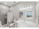 Modern bathroom with a walk-in shower, white vanity, and a decorative mirror at 9861 Eagle Preserve Dr, Englewood, FL 34224