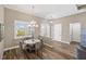 Cozy dining area with a chandelier, a decorative table and shuttered windows at 9861 Eagle Preserve Dr, Englewood, FL 34224