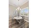 Elegant dining area with a modern chandelier and large shuttered windows at 9861 Eagle Preserve Dr, Englewood, FL 34224