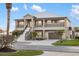 Lovely two-story home featuring dual staircases, balconies, and a three-car garage at 9861 Eagle Preserve Dr, Englewood, FL 34224