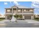 Elegant two-story home with a metal roof, dual garages, and a welcoming grand entrance with well-maintained landscaping at 9861 Eagle Preserve Dr, Englewood, FL 34224