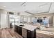 Open-concept kitchen featuring stainless steel appliances and views into an adjacent living space at 9861 Eagle Preserve Dr, Englewood, FL 34224