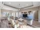 Spacious living room featuring a ceiling fan and a decorative mural art wall at 9861 Eagle Preserve Dr, Englewood, FL 34224