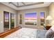 This main bedroom has large windows with breathtaking views of the water at 9861 Eagle Preserve Dr, Englewood, FL 34224