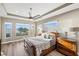 This sun-filled main bedroom features water views, wood floors, and contemporary finishes at 9861 Eagle Preserve Dr, Englewood, FL 34224