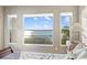 This water view main bedroom boasts triple windows and a beautiful view at 9861 Eagle Preserve Dr, Englewood, FL 34224