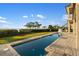 Backyard pool area with a tanning ledge, stairway, and unobstructed water view at 9861 Eagle Preserve Dr, Englewood, FL 34224