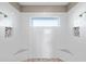 This shower is adorned with multiple shower heads and built-in shelves, and a stone floor at 9861 Eagle Preserve Dr, Englewood, FL 34224