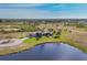 Aerial view showcasing a house, pool, and lush landscaping at 1 Calm Ct, Placida, FL 33946