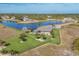 Aerial view showcasing a house with a fenced backyard and a pond nearby at 1 Calm Ct, Placida, FL 33946