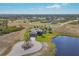 Aerial view of single-Gathering home with circular driveway and pond at 1 Calm Ct, Placida, FL 33946