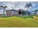 Single story home with a two car garage and lush green lawn at 1 Calm Ct, Placida, FL 33946