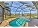 Relaxing kidney-shaped pool with screened enclosure offering tranquil water views at 1 Calm Ct, Placida, FL 33946