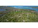 Aerial view of waterfront property with lush vegetation and access to the ocean at 10451 Sherman St, Englewood, FL 34224