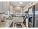 Modern kitchen featuring white cabinets, granite counters, and stainless steel appliances at 10451 Sherman St, Englewood, FL 34224