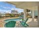 Relaxing pool area with patio furniture, offering waterfront views at 10451 Sherman St, Englewood, FL 34224