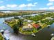 Waterfront property showcasing a large home and private dock at 10544 Poughkeepsie Cir, Port Charlotte, FL 33981