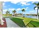 Waterfront backyard with a patio and lush landscaping at 10544 Poughkeepsie Cir, Port Charlotte, FL 33981