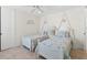 Well-lit bedroom with twin beds and access to a hallway at 10544 Poughkeepsie Cir, Port Charlotte, FL 33981