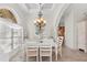 Bright dining room with white table and chairs, and a chandelier at 10544 Poughkeepsie Cir, Port Charlotte, FL 33981