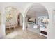 Elegant dining room with arched entryway and chandelier, adjacent to living area at 10544 Poughkeepsie Cir, Port Charlotte, FL 33981