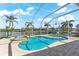 Inviting heated pool and spa with screened enclosure and water views at 10544 Poughkeepsie Cir, Port Charlotte, FL 33981