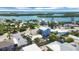 Aerial view of neighborhood homes near water and tropical trees at 1100 Gulf Blvd, Englewood, FL 34223