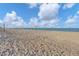 Beautiful sandy beach with a volleyball net and clear blue ocean in the background at 1100 Gulf Blvd, Englewood, FL 34223