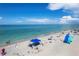 Beautiful beachfront featuring white sand and crystal-clear turquoise water under a clear blue sky at 1100 Gulf Blvd, Englewood, FL 34223