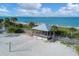 Picturesque gazebo on the beach with volleyball net and palm trees at 1100 Gulf Blvd, Englewood, FL 34223