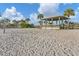 Picturesque gazebo on the beach with volleyball net and palm trees at 1100 Gulf Blvd, Englewood, FL 34223