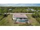 Aerial view of the backyard featuring a screened-in pool area at 12075 Duval Blvd, Port Charlotte, FL 33981