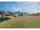 Expansive backyard featuring a screened-in pool enclosure at 12075 Duval Blvd, Port Charlotte, FL 33981