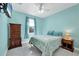 Bedroom with a queen-size bed, dresser, and light-blue walls at 12075 Duval Blvd, Port Charlotte, FL 33981