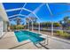 Inviting screened pool area with lounge chairs and patio furniture at 12075 Duval Blvd, Port Charlotte, FL 33981