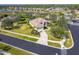 Aerial view of single-story house with pool and landscaped yard in a residential community at 12650 Montigello Ct, Englewood, FL 34223