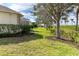 Landscaped backyard with mature trees and hedges at 12650 Montigello Ct, Englewood, FL 34223