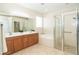 Bathroom with double vanity, garden tub, and walk-in shower at 12650 Montigello Ct, Englewood, FL 34223